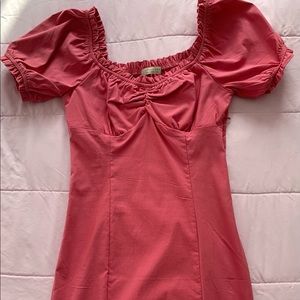 Pink bodycon dress with sleeves.
